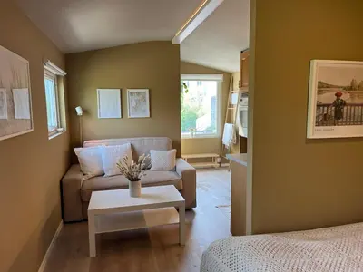 a living room with a couch and a table at Cozy studio near Bergen in Bergen
