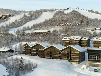 an aerial view of a resort in the snow at Homey Apartment Steps From Dining And Activities! in Beitostøl