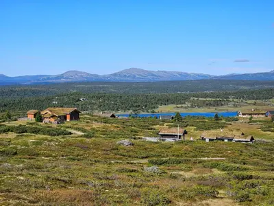 a view of a field with houses and a lake at Varden in Sør-Fron