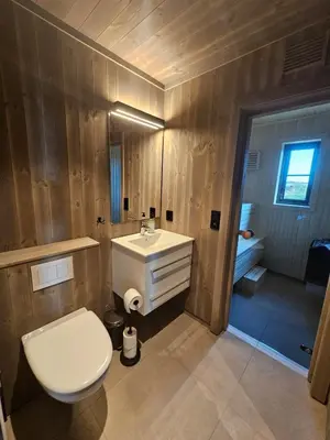 a bathroom with a white toilet and a sink at Varden in Sør-Fron