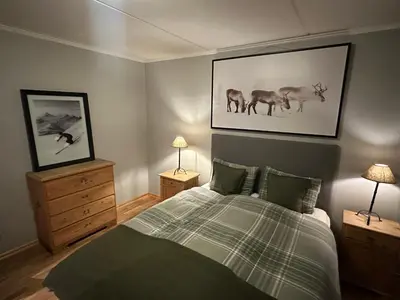 a bedroom with a bed with two night stands and two lamps at Charming 2-Bedroom Apartment In Beitostølen in Beitostøl