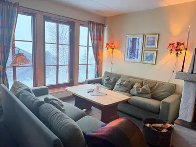 a living room with a couch and a table at Central Apartment With Garage, Views, Ski In And Out in Beitostøl