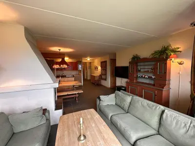 a living room with a couch and a table at Central Apartment With Garage, Views, Ski In And Out in Beitostøl