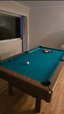 a pool table with a ball on top of it at Knobelauch Family Home, Valdres in Vøle