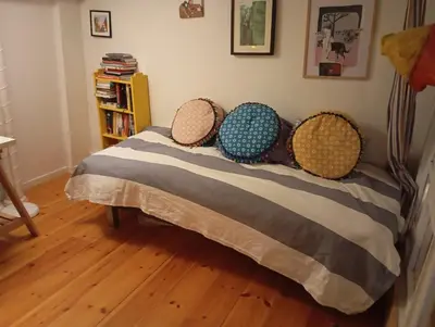 a bed with four pillows on it in a room at Nice two-floor home by Gamle bybro in Trondheim