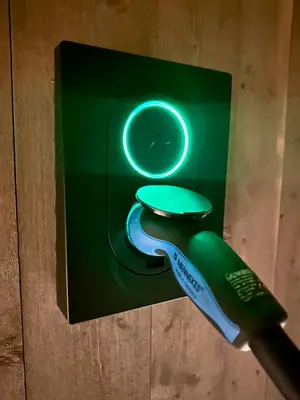 a green electric toothbrush and a clock on a box at Immaculate Cabin in the Heart of Beitostølen in Beitostøl