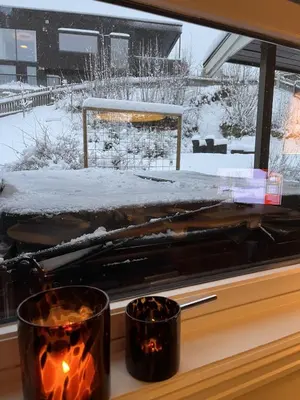 a window with snow on the ground and two candles at Large single-family home on Dalgård with walking distance to VM2025 in Trondheim