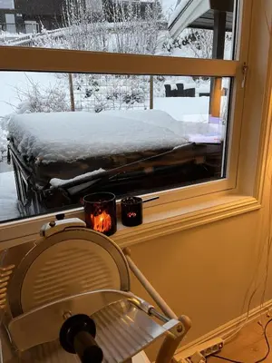 a window with a chair in front of a snow covered yard at Large single-family home on Dalgård with walking distance to VM2025 in Trondheim