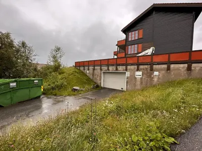 a building with a garage in front of it at Family-Friendly Stay With Stunning Mountain Views! in Beitostøl
