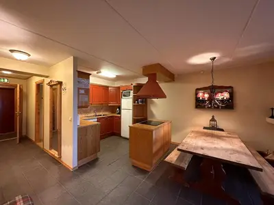 a kitchen with a wooden table in the middle of it at Family-Friendly Stay With Stunning Mountain Views! in Beitostøl