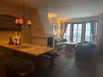 a living room with a table and a fireplace at Family-Friendly Stay With Stunning Mountain Views! in Beitostøl