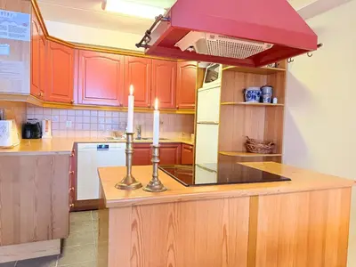 a kitchen with orange cabinets and two candles on a counter at Family-Friendly Stay With Stunning Mountain Views! in Beitostøl
