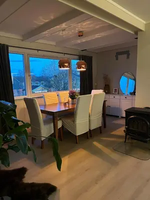a dining room with a table and chairs at Horizontal half at Byaasen in Trondheim