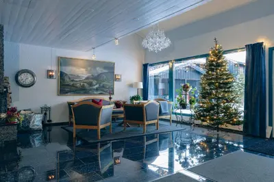 a living room with a christmas tree in it at Solheimen konferansehotell AS in Hedalen