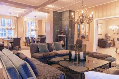 a living room with a couch and a table at Solheimen konferansehotell AS in Hedalen