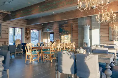 a dining room with a table and chairs and a chandelier at Solheimen konferansehotell AS in Hedalen