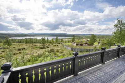 a wooden deck with a view of a lake at Hytteperle Gålå, Vakre Lauvåsen, Hønhuset in Sør-Fron
