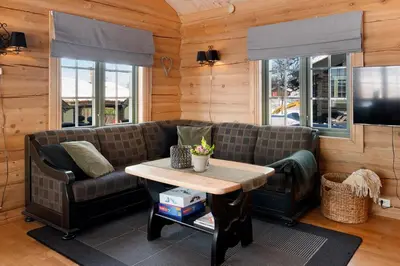 a living room with a couch and a table at Hytteperle Gålå, Vakre Lauvåsen, Hønhuset in Sør-Fron