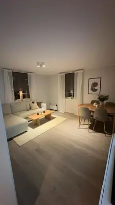 a living room with a couch and a table at Leilighet på Byåsen, i nærheten av Granåsen in Trondheim