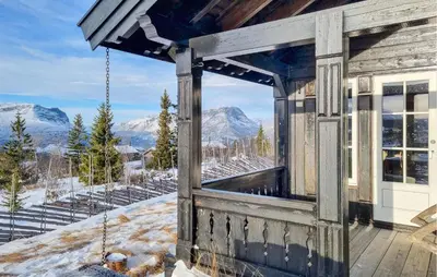 a house with a balcony with a view of mountains at Gorgeous Home In Vang I Valdres in Vang I Valdres
