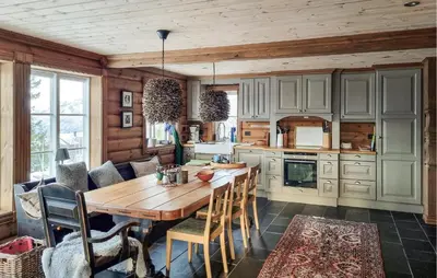 a kitchen with a wooden table and chairs at Gorgeous Home In Vang I Valdres in Vang I Valdres