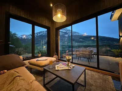 a living room with a couch and a table at Olden house 65 in Stryn