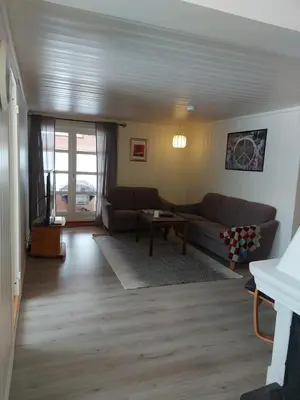 a living room with a couch and a table at Huset med utsikt til innsjøen -8 min til Gjøvik sentrum in Gjøvik