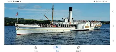 a large white boat in the water with people on it at Huset med utsikt til innsjøen -8 min til Gjøvik sentrum in Gjøvik