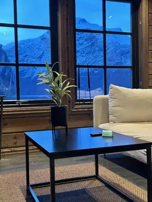 a living room with a couch and a table at Cabin by the fjord in Geiranger