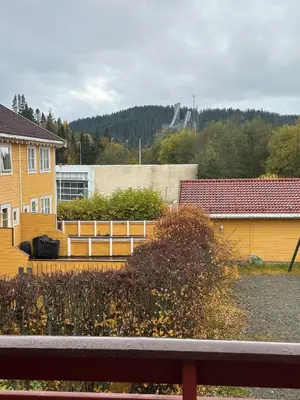 a view of a yard with a house and a fence at House near Granåsen Ski Arena in Trondheim