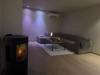 a living room with a couch and a fireplace at Modern Home with a View, Easy access to World Ski Championships in Malvik