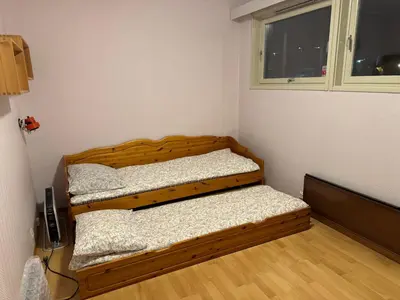 two beds in a room with a window at Modern Home with a View, Easy access to World Ski Championships in Malvik