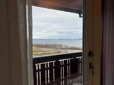 a window with a view of the water at Modern Home with a View, Easy access to World Ski Championships in Malvik