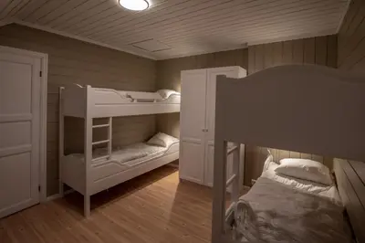 a room with two bunk beds and a bed at Bakkebyvegen 15A in Trysil