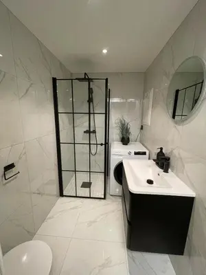 a bathroom with a shower and a sink and a toilet at Newly renovated apartment in the middle of Trondheim city centre in Trondheim