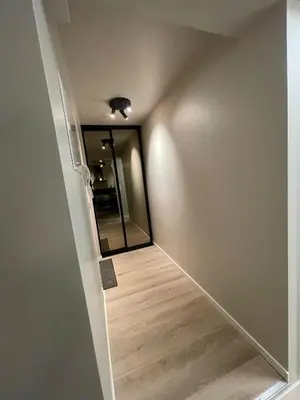 a hallway with a mirror on the wall at Newly renovated apartment in the middle of Trondheim city centre in Trondheim