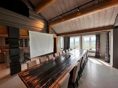 a large conference room with a long table and chairs at Bjørndalenhytta in Beitostøl