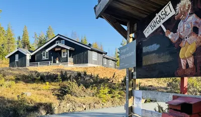 a sign in front of a black house at Newly renovated cabin in Nesfjellet, Nesbyen in Nesbyen