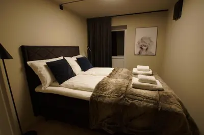 a bedroom with a large bed with towels on it at Comfort Apartment in Lone Only 20 minutes away from the heart of the city! in Bergen