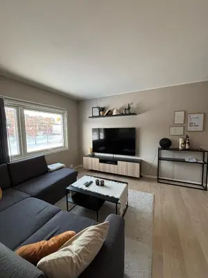 a living room with a couch and a tv at Ski VM 2025 in Trondheim
