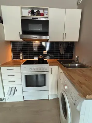 a kitchen with a stove and a microwave at Ski VM 2025 in Trondheim