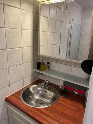 a bathroom with a sink and a mirror on a counter at Top floor, cozy apartment, centrally located in Trondheim in Trondheim