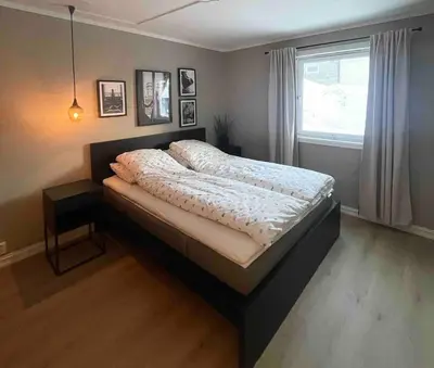a bed in a bedroom with a window at Newly renovated apartment for rent in Stjoerdal
