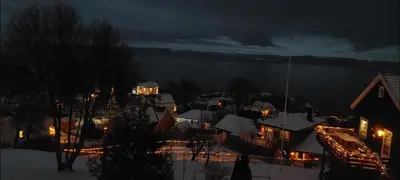 a town at night with snow on the ground at Close to the Airport and Trondheim in Malvik