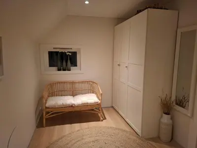a small room with a bench and a cabinet at Close to the Airport and Trondheim in Malvik