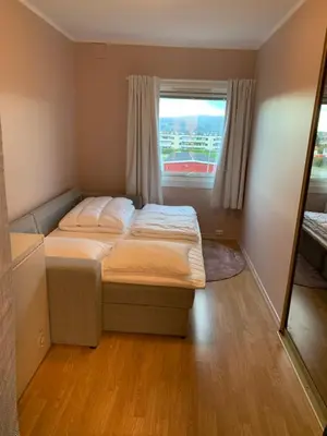 a small bedroom with a bed and a window at 2 bedrooms apartment in Trondheim