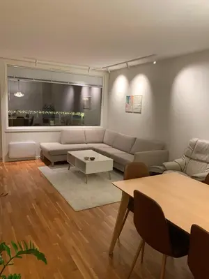a living room with a couch and a table at 2 bedrooms apartment in Trondheim