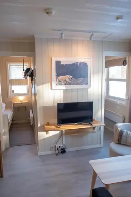 a living room with a flat screen tv on a wall at Alpinlandsbyen - Ski in - Ski out -Nr 34 in Hafjell