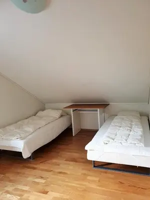 two beds in a room with a table on top at Mountain view 1 in Håra