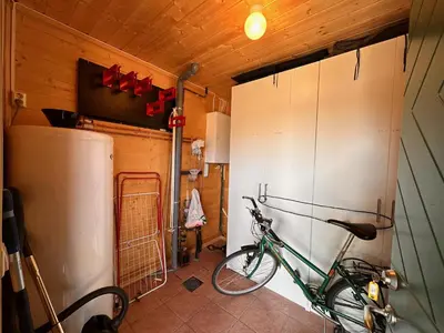 a bike parked in a room with a refrigerator at Beitotind 1504 in Beitostøl